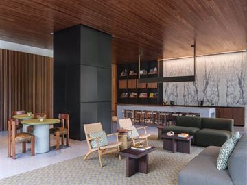 Los Angeles apartment for rent - A living room with a grey couch and wooden chairs.