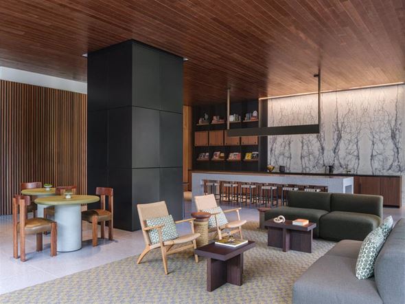 Los Angeles apartment for rent - A living room with a grey couch and wooden chairs.