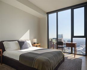 Los Angeles apartment for rent - A bedroom with a large bed and a view of the city.