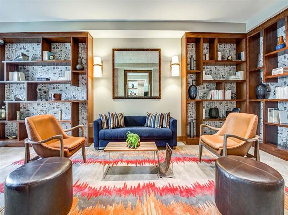 Northridge apartment for rent - a living room with a blue couch and bookshelves