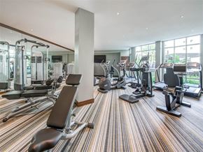 Northridge apartment for rent - A gym with a variety of equipment including treadmills, weights, and exercise machines.