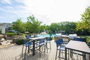 Charlotte apartment for rent - a patio with tables and chairs next to a swimming pool