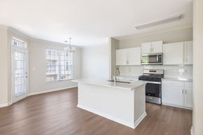 Alexandria apartment for rent - A kitchen with white cabinets and a wooden floor.