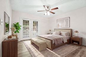 Charlotte apartment for rent - A bedroom with a bed, nightstand, and a plant.