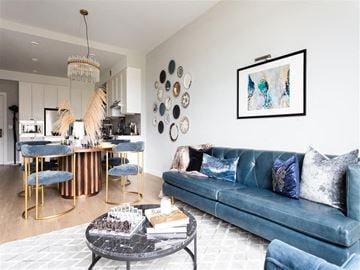 Washington apartment for rent - A living room with a blue couch and a coffee table.