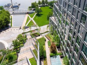 Washington apartment for rent - A modern building with a green space in front of it.