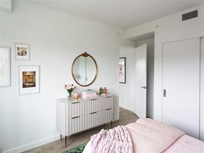 Washington apartment for rent - a bedroom with a white dresser and a mirror