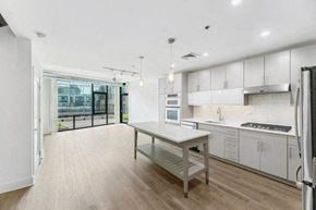 Washington apartment for rent - a large kitchen with a table and a refrigerator