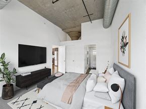 Washington apartment for rent - a bedroom with a bed and a tv on the wall