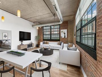 Washington apartment for rent - A modern living room with a white dining table and grey sofa.