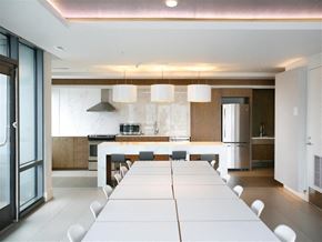 Washington apartment for rent - a long dining table in a large kitchen with white tiles