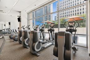 Dallas apartment for rent - A gym with treadmills and a view of the city.