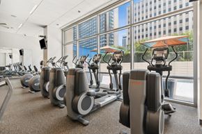 Dallas apartment for rent - A gym with treadmills and a view of the city.
