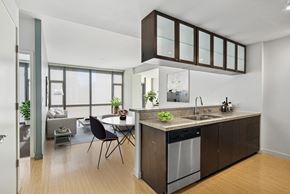 Dallas apartment for rent - A modern kitchen with a dining table and chairs.