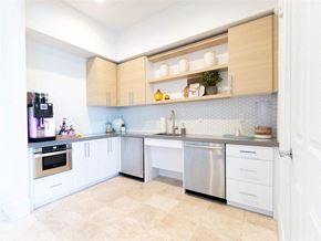 Miramar apartment for rent - A kitchen with white cabinets and a tiled backsplash.