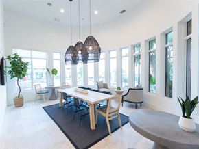 Miramar apartment for rent - a dining room with a table and chairs and large windows