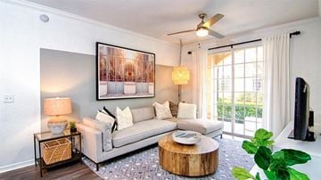 Miramar apartment for rent - A living room with a white couch, a coffee table, and a painting on the wall.