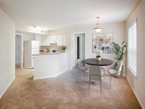 Orlando apartment for rent - an open kitchen and dining room with a table and chairs