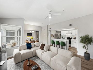 Orlando apartment for rent - A living room with a white couch and a brown coffee table.