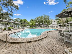 Tampa apartment for rent - a swimming pool with umbrellas and chairs around it