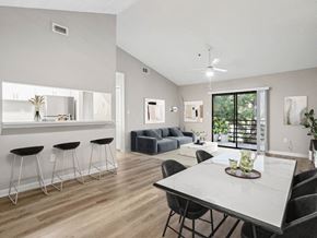 Tampa apartment for rent - A modern dining room with a white table and black chairs.