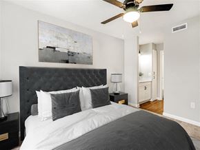Tampa apartment for rent - a bedroom with a bed and a ceiling fan