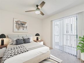 Tampa apartment for rent - a bedroom with a bed and a ceiling fan