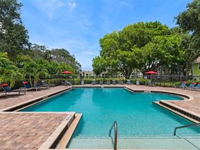 West Palm Beach apartment for rent - a large swimming pool with chairs in it