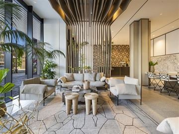 Honolulu apartment for rent - a living room with couches and chairs and a table
