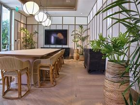 Honolulu apartment for rent - A room with a long table and chairs with a television on the wall.