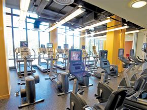 Chicago apartment for rent - a gym with cardio equipment and windows in a building