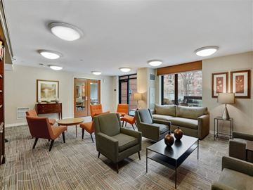 Chicago apartment for rent - A living room with a variety of furniture including a couch, chairs, and a coffee table.
