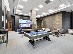 Chicago apartment for rent - a games room with a pool table and two televisions