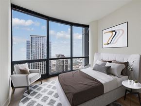 Chicago apartment for rent - a bedroom with a bed and a view of the city