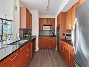 Chicago apartment for rent - a large kitchen with wooden cabinets and stainless steel appliances