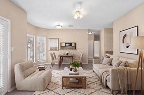 Garland apartment for rent - A living room with a sofa, armchair, and coffee table.