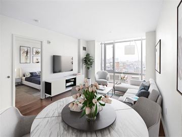 Cambridge apartment for rent - A modern living room with a grey round table and grey chairs.