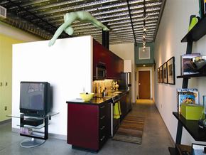 Cambridge apartment for rent - A kitchen with a red cabinet and a television.
