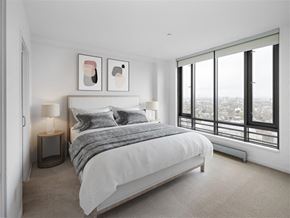 Cambridge apartment for rent - A bedroom with a large bed and a view of the city.