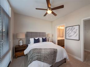 Baltimore apartment for rent - a bedroom with a bed and a ceiling fan