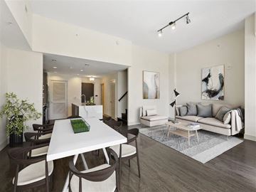 Silver Spring apartment for rent - A modern living room with a white dining table and brown chairs.