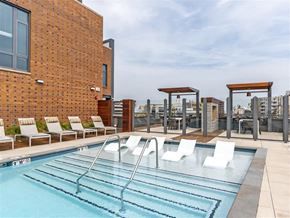 Silver Spring apartment for rent - a swimming pool on the rooftop of a building with chairs