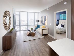 Silver Spring apartment for rent - A modern bedroom with a large bed and a wooden dresser.