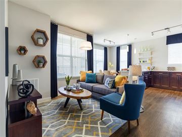 Mt Laurel Township apartment for rent - A blue chair sits in a living room with a grey couch and a coffee table.