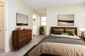 Raleigh apartment for rent - A bedroom with a bed, dresser, and mirror.