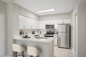 Miramar apartment for rent - A modern kitchen with white cabinets and appliances.