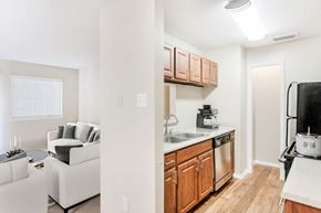 Mckinney apartment for rent - A kitchen with wooden cabinets and a white countertop.