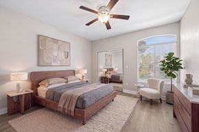 Las Vegas apartment for rent - A bedroom with a large bed and a ceiling fan.