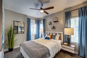 Las Vegas apartment for rent - A bedroom with a large bed and a ceiling fan.