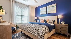 Wilmington apartment for rent - a bedroom with a bed and a blue accent wall